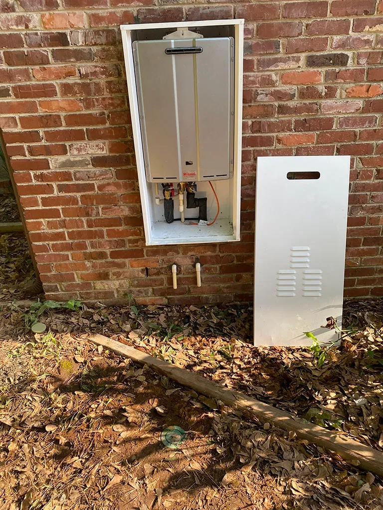 Outdoor tankless water heater in a recessed wall box