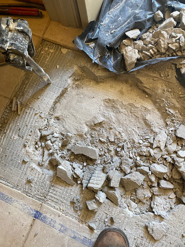 Floor broken up to reach a drain line under the slab